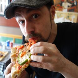 Eating pizza at Amico's Pizza in Parkdale Toronto