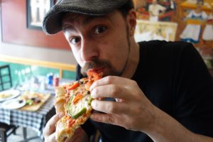 Eating pizza at Amico's Pizza in Parkdale Toronto