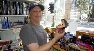 Kirk holds super hero piggybank made by 3d printing Toronto